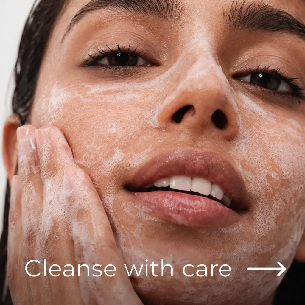 a woman rubbing her face with face wash